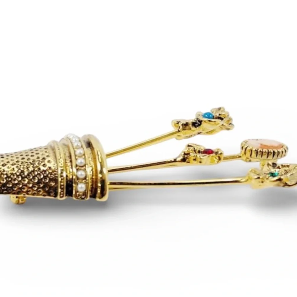Vintage gold-plated thimble brooch with five stick pins.